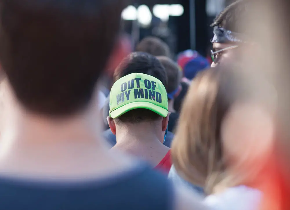 A Man Wearing a Hat that says "Out of My Mind"