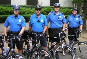 Four campus policemen on bikes