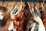 Young woman shopping for clothes at a clothing store or thrift store