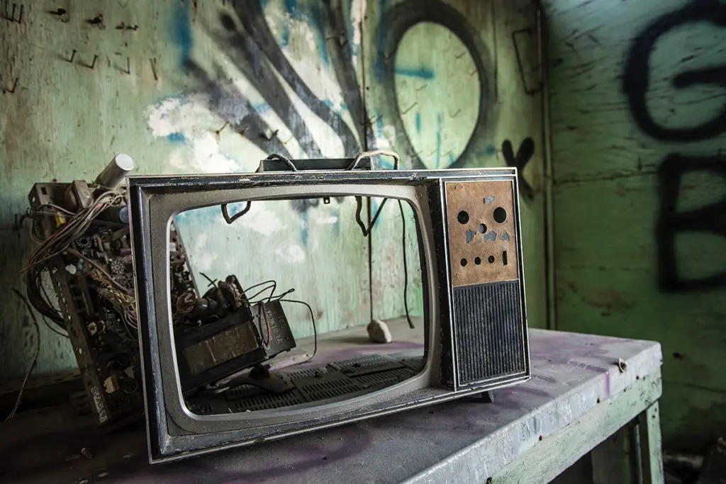 broken ruined destroyed damaged vintage television in abandoned graffitied room image by tina rataj berard on unsplash