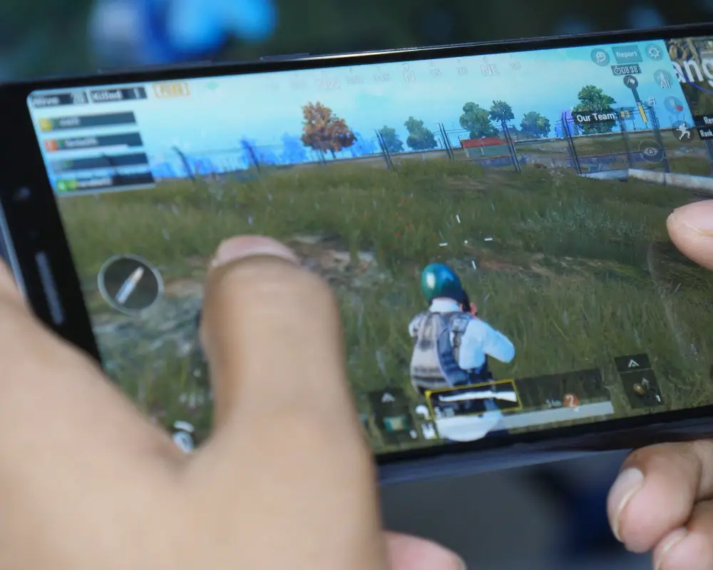 Someone playing PubG on a handheld device