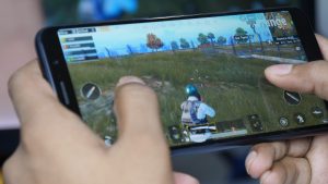 Someone playing PubG on a handheld device