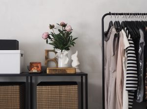 minimalistic bedroom with a dresser and clothes rack