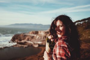 Woman with bouquet of flowers in article about marijuana