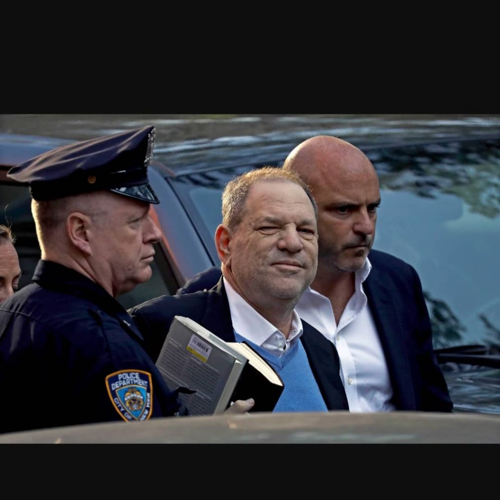 Harvey Weinstein escorted by police officer in article about events other than COVID-19 that took place in March