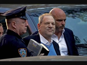 Harvey Weinstein escorted by police officer in article about events other than COVID-19 that took place in March