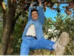 James Charles hanging from a tree.