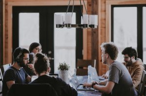 In an article about what to do after college, a picture of four people on laptops working around a desk