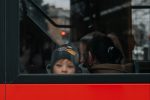 In an article about gender, a photo a child looking out the back window of a bus