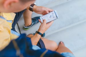 Image of a person looking at their phone as they go online