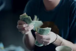 College student counting money