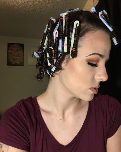 person using straws to curl hair in article about TikTok trends