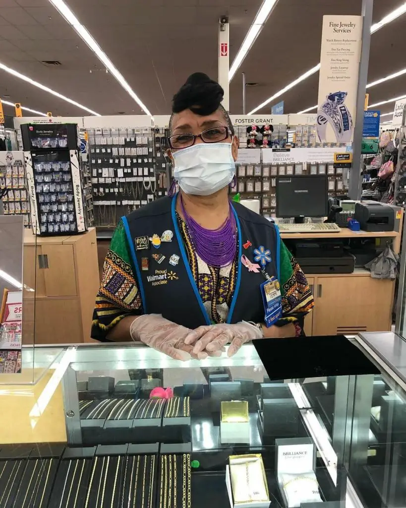 retail worker in one of many essential businesses wearing a mask