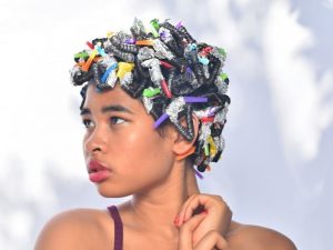 Zenna De Paz modeling using straws to curl hair, one of several TikTok life hacks