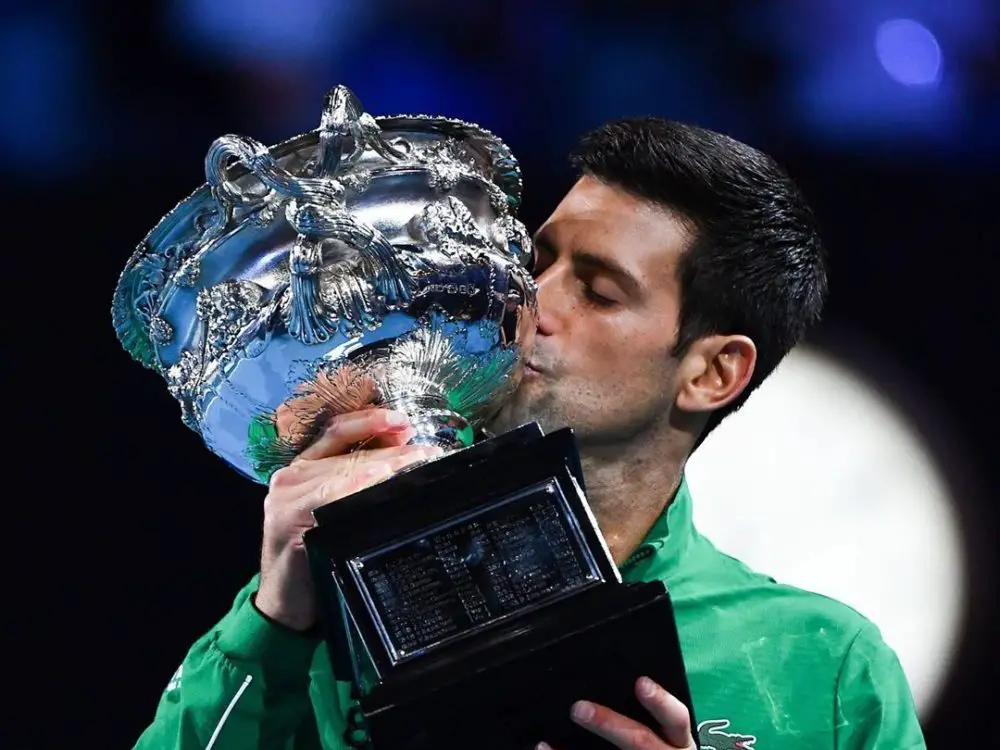 Novak Djokovic kissing a trophy