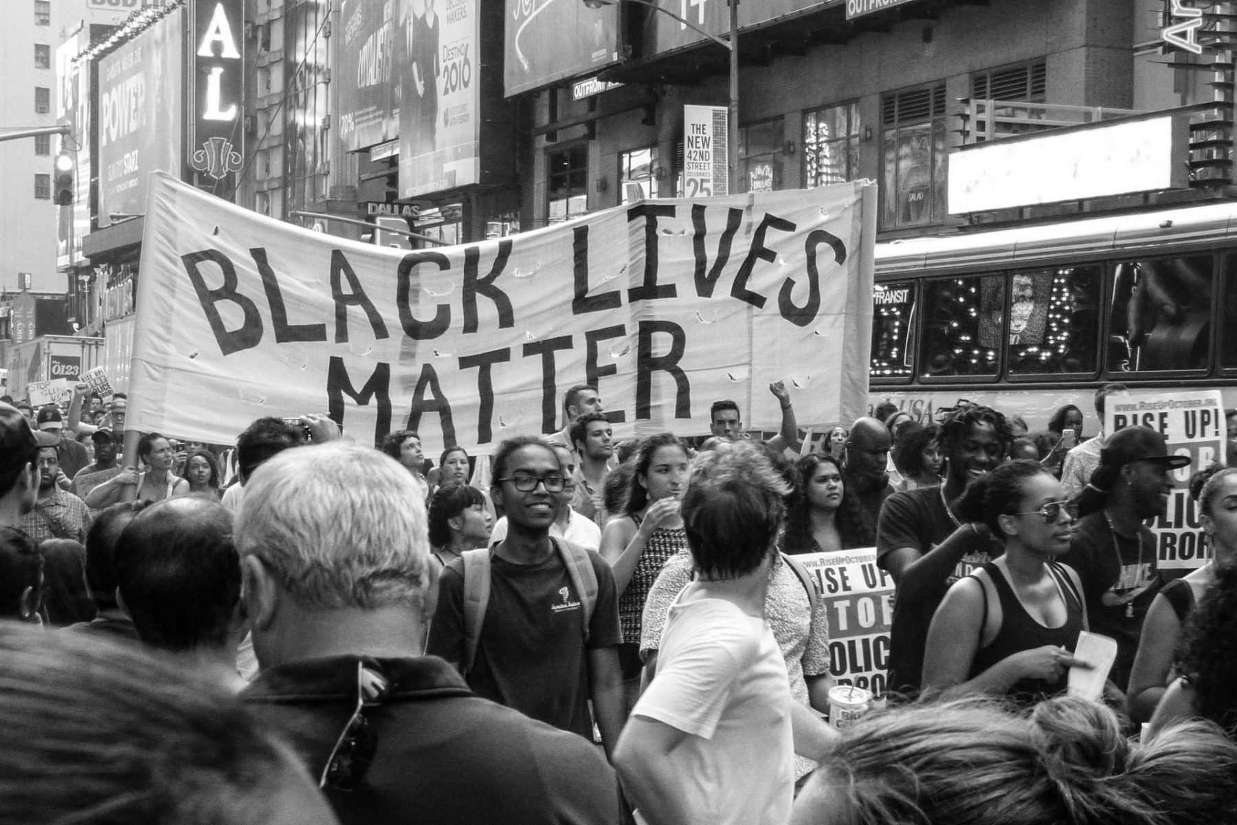 Protesters march alongside a "Black Lives Matter" banner at one of many protests across the globe