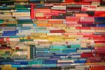 Writing for diversity: book spines arranged by color to resemble a rainbow.