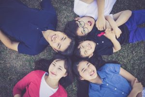 In an article about the 2020 census, a smiling family lies on the grass together