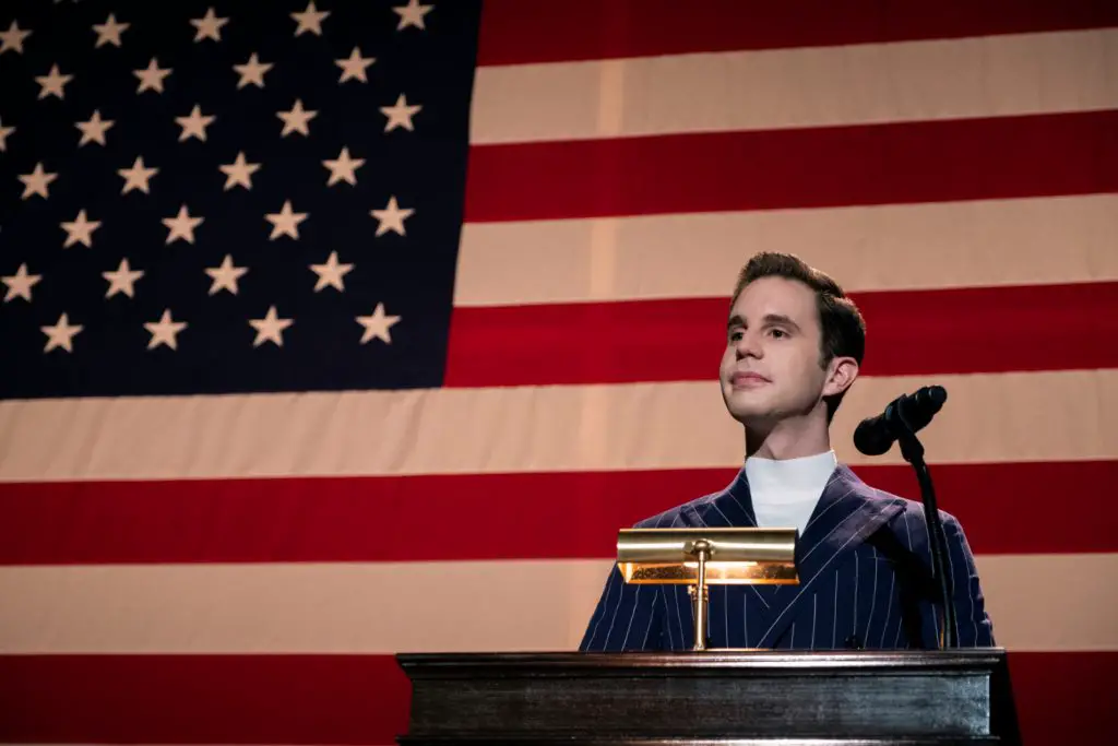 Ben Platt as Payton Hobart gives a political speech in front of the American flag in The Politician.