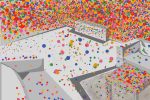 An artistic depiction of Kusama's 3D artwork of a room covered in polka dots.