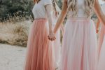 women in pink skirts holding hands; toxic femininity