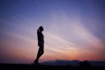 in article about working out when you have disordered behaviors, photo of person silhouetted against sunset