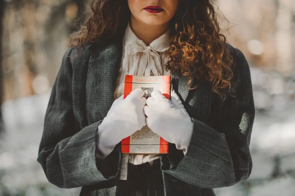In an article about whether to finish a book you hate reading, an image of a woman clutching a book