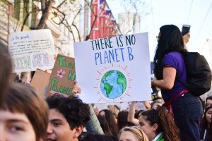 In an article about Joe Biden and the climate crisis, a photo of protesters and a sign reading, "There is no Planet B."