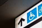 In article about disabled college students returning to campus, an image of an accessibility sign