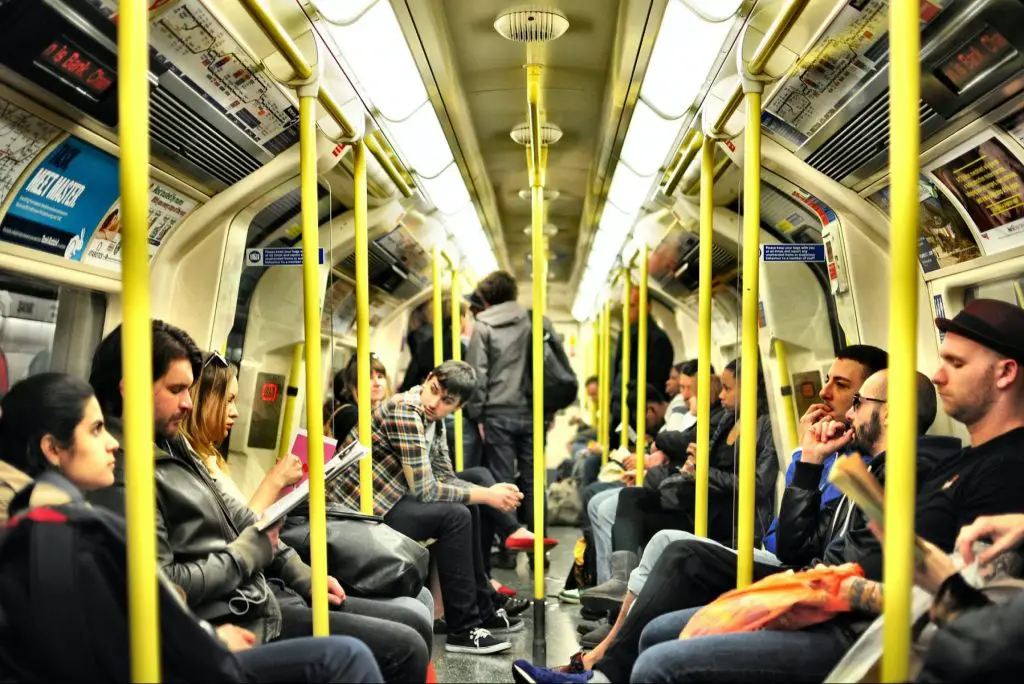 A photo of commuters on the subway in an article about college reopening plans