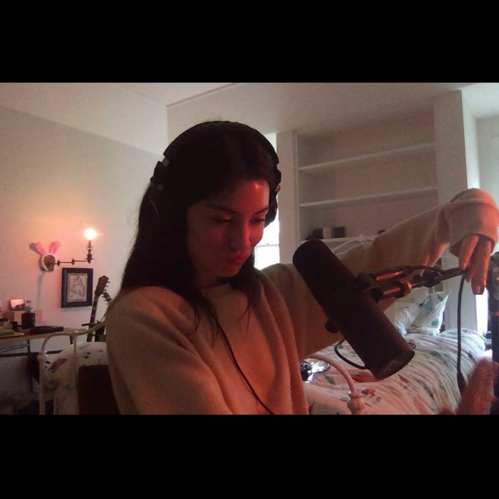 In an article about her new EP, minor, a photo of Gracie Abrams in her bedroom with her recording equipment