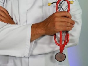 In an article about the coronavirus and living with parents in the medical profession, a photo of a doctor holding a stethoscope