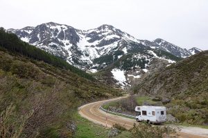 An RV traveling down a road to Harvest Hosts