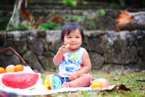 Image of a baby eating food in an article about baby-led weaning