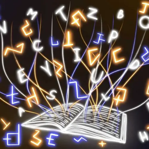 in an article about conlanging, an illustration of an open book with letters surrounding it on all sides