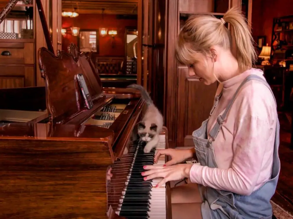 A photo of Taylor Swift playing the piano in the Miss Americana documentary. (Image via Google Images)