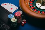 in an article about nice online casino games, a roulette wheel, playing cards and casino chips
