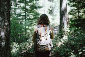 A photo of a woman hiking for an article about hiking trails in Georgia. (Photo by Jake Melara from Unsplash)