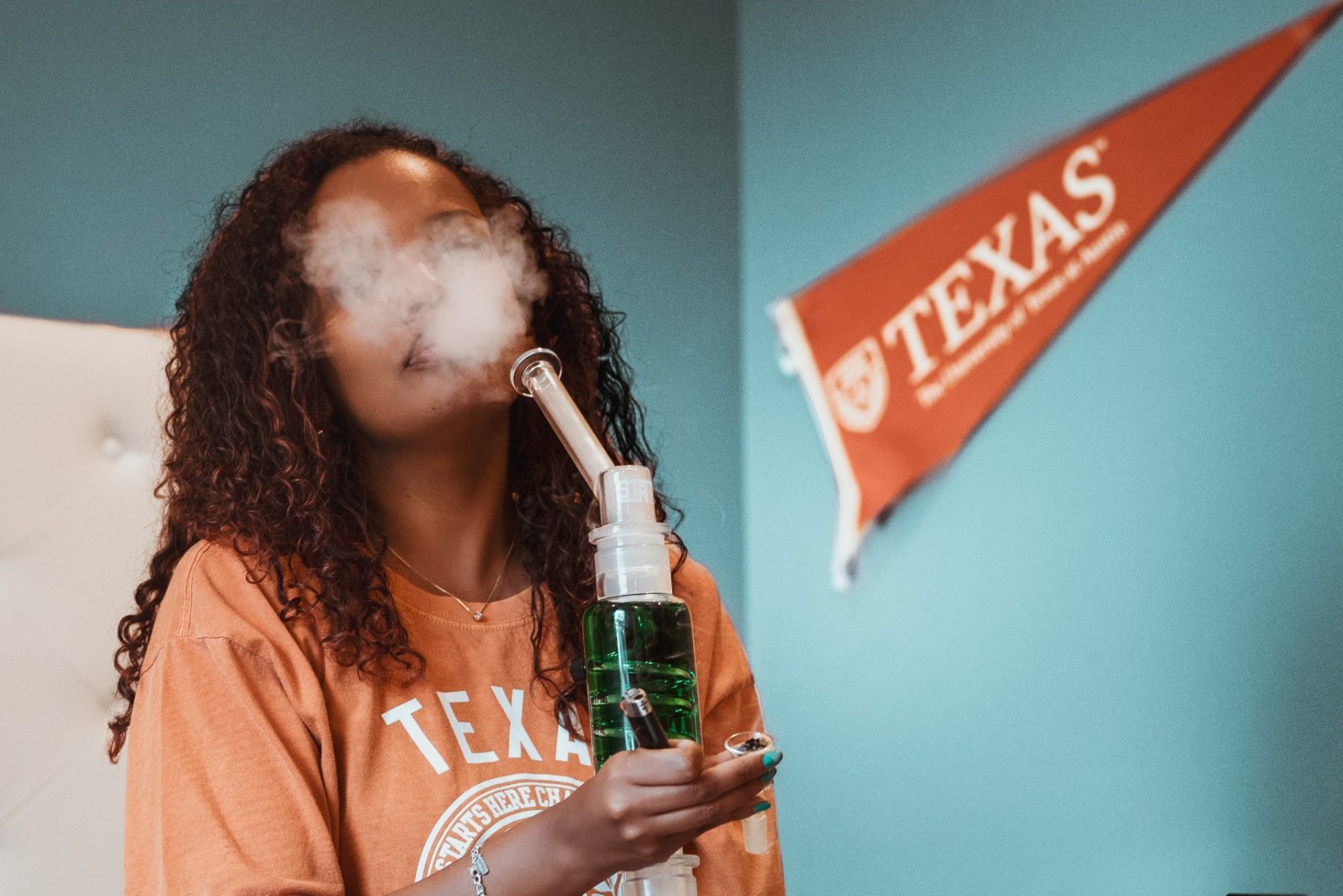 in an article about bongs, someone smoking out of a bong