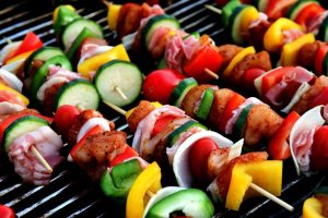 photo of meat and vegetable skewers on a barbecue grill