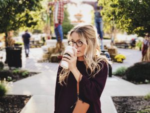 person drinking coffee in article about birthday freebies