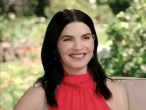 A picture of actress Julianna Margulies against a garden backdrop.