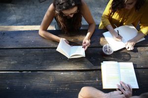 In article about MBTI test, three people with open books on a table