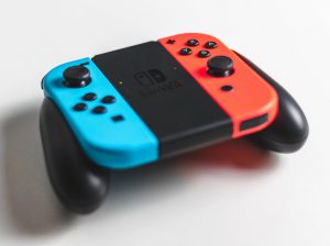 A red and blue Nintendo Switch controller on a white background.