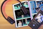 Illustrations of headphones on top of a graphic novel with a phone showing an audiobook.