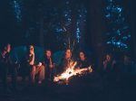 A group of friends around a campfire — the perfect place to read Tolkien