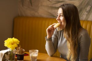 in an article about maintaining health and healthy eating in the dining hall, a person eating a breakfast food