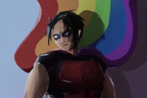 In an article about Tim Drake, Robin stands against a blue sky and a rainbow flag.