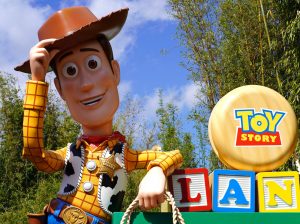 In an article about animation, a statue of Woody leans agnaist the sign of Toy Story's toyland.