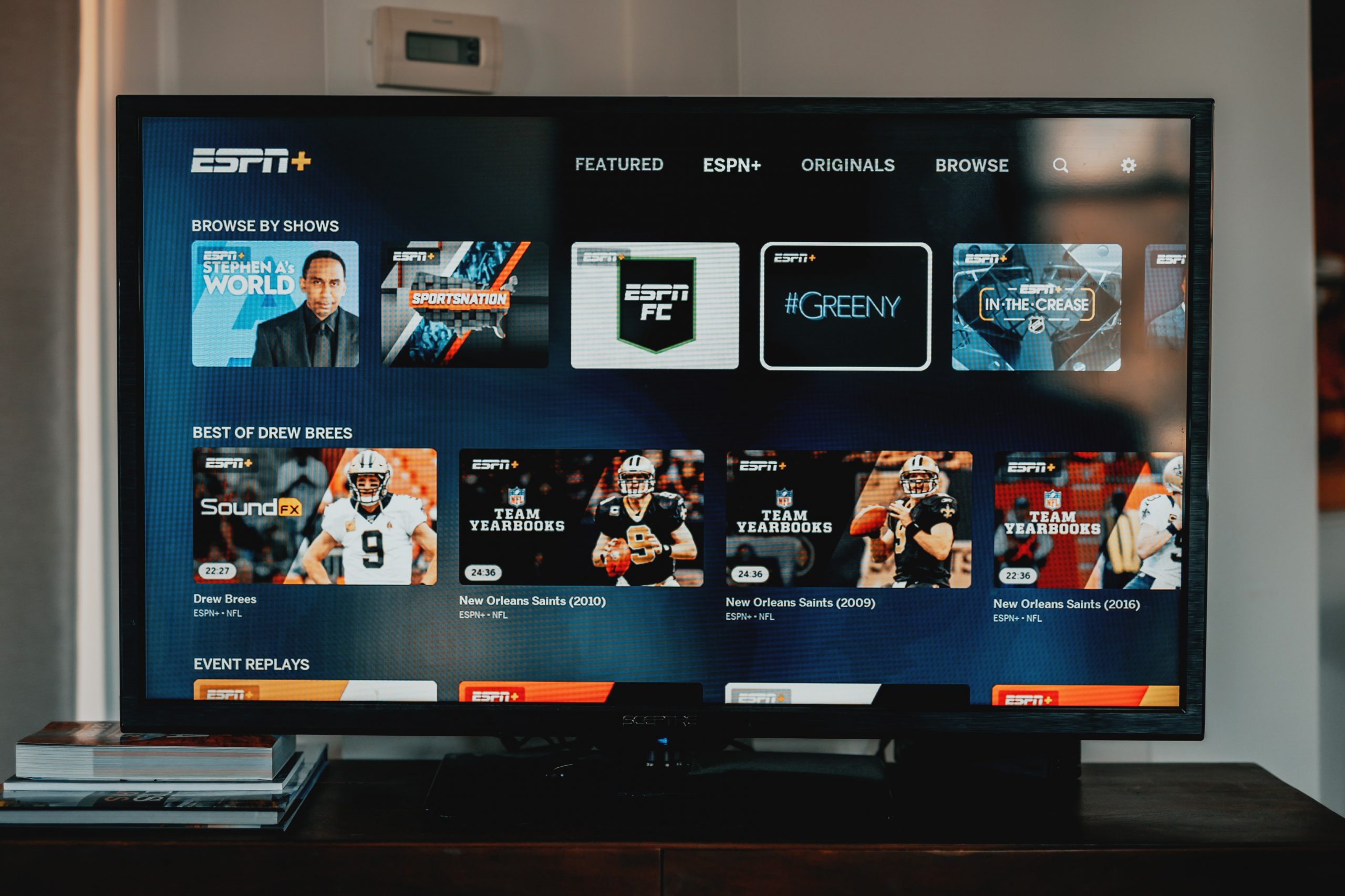 In an article about sports coverage, a photograph of a flat screen TV with ESPN+ on the screen.